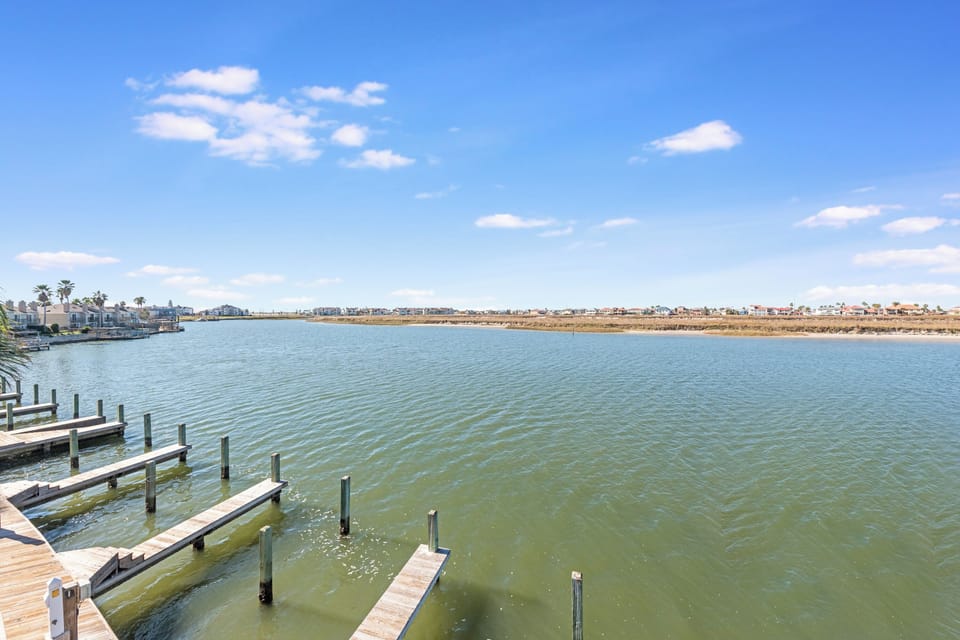 Waterfront community with rental docks stretching across calm waters under clear blue skies.