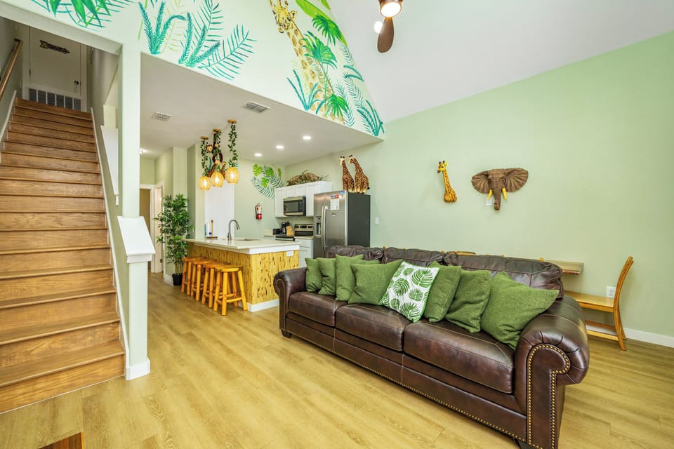 Unwind in your stylish safari-themed living space with plush leather sofa, full kitchen, and whimsical jungle touches throughout.