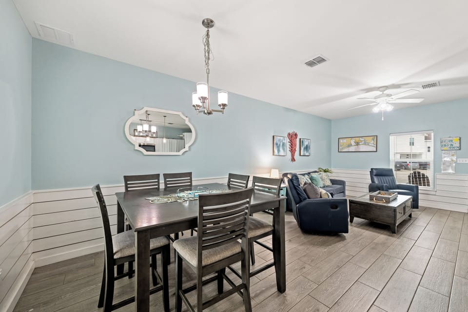 Settle in at your spacious dining table, perfect for meals and game nights, while relaxing in the cozy living area just steps away.