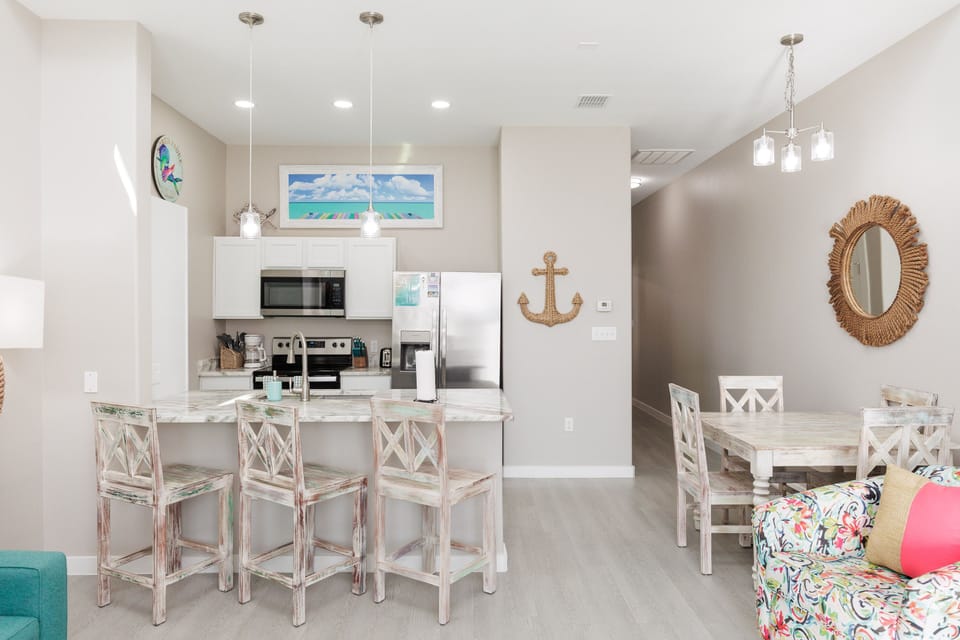 You'll love this bright, coastal-themed space where kitchen, dining, and living flow together perfectly for your beachside getaway.