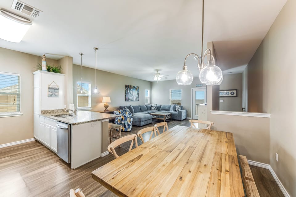 Open-plan living zone with cozy seating and flat screen TV to enjoy with the family