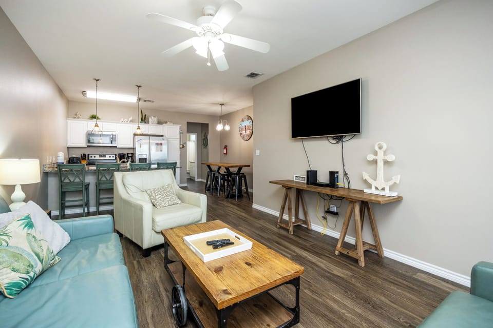 The kitchen, dining, and living areas blend seamlessly for a bright and airy feel