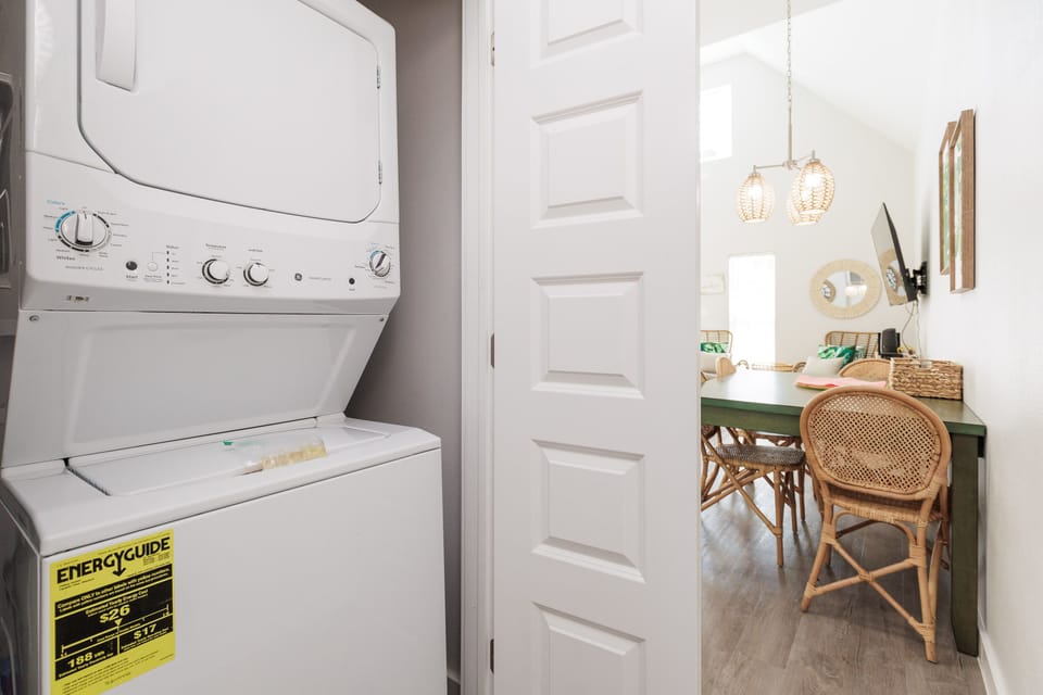 Keep your wardrobe fresh with in-unit laundry, then settle into your stylish workspace with natural textures and warm lighting.