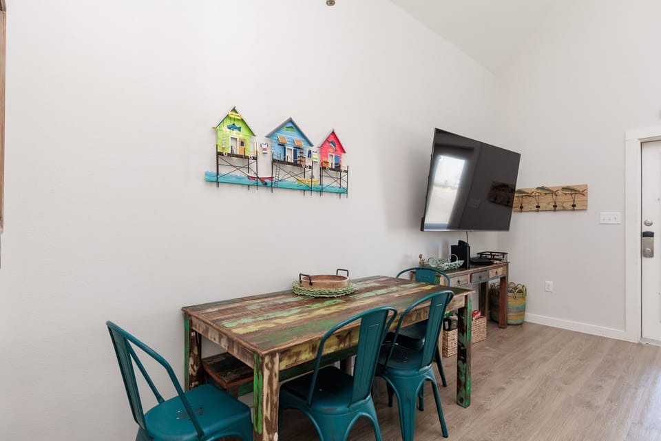 Gather around your stylish dining table with coastal artwork creating the perfect backdrop for memorable meals and game nights together.