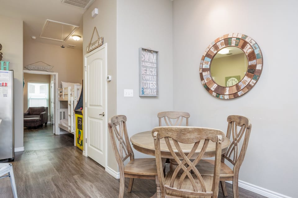 Gather around your charming dining table for morning coffee or evening meals, with coastal-themed decor creating a relaxed beach house atmosphere.