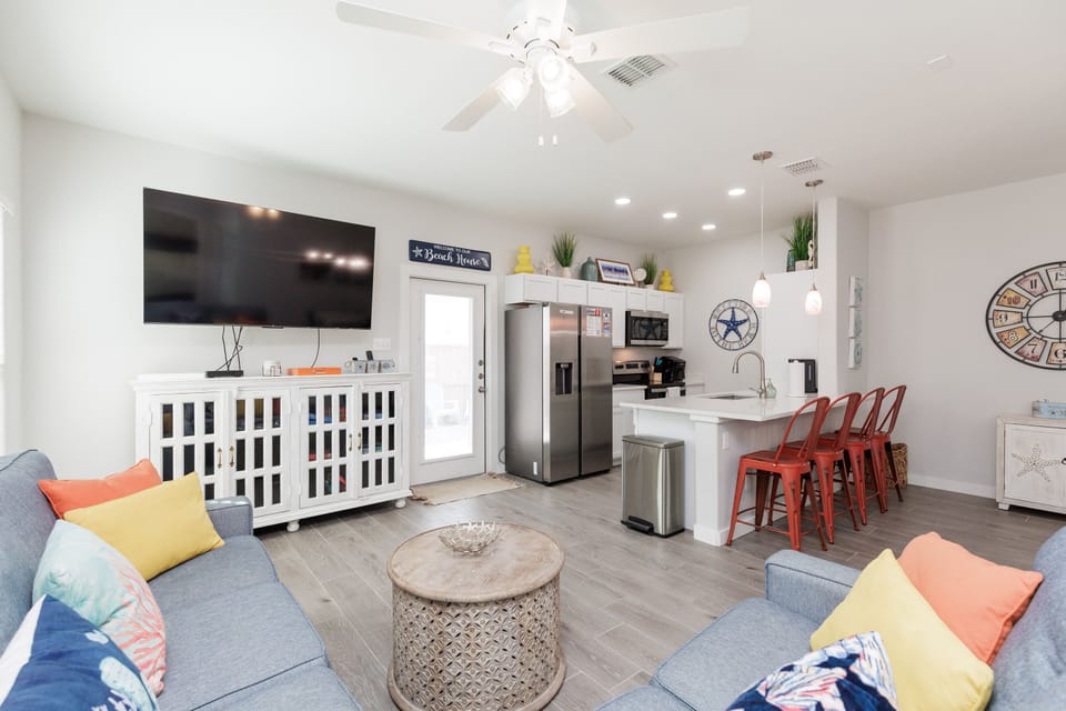 Unwind in your bright open-concept living space with coastal charm, modern kitchen, and cheerful accents that make you feel right at home.