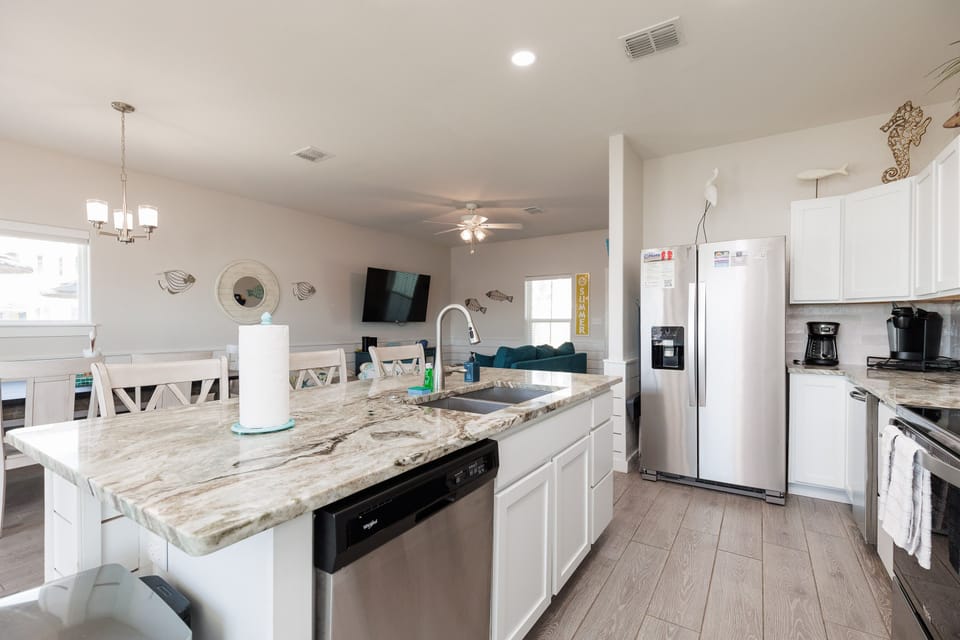 Your spacious kitchen features marble countertops, stainless appliances, and an island perfect for morning coffee or meal prep together.