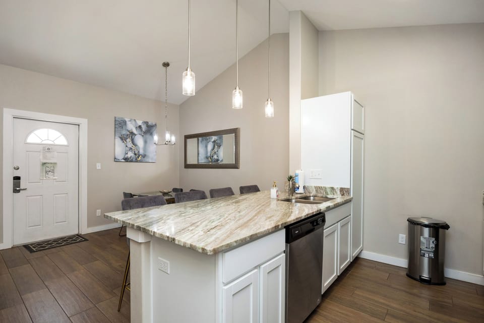 Your stylish kitchen island offers marble countertops and pendant lighting, perfect for preparing meals and gathering with loved ones.