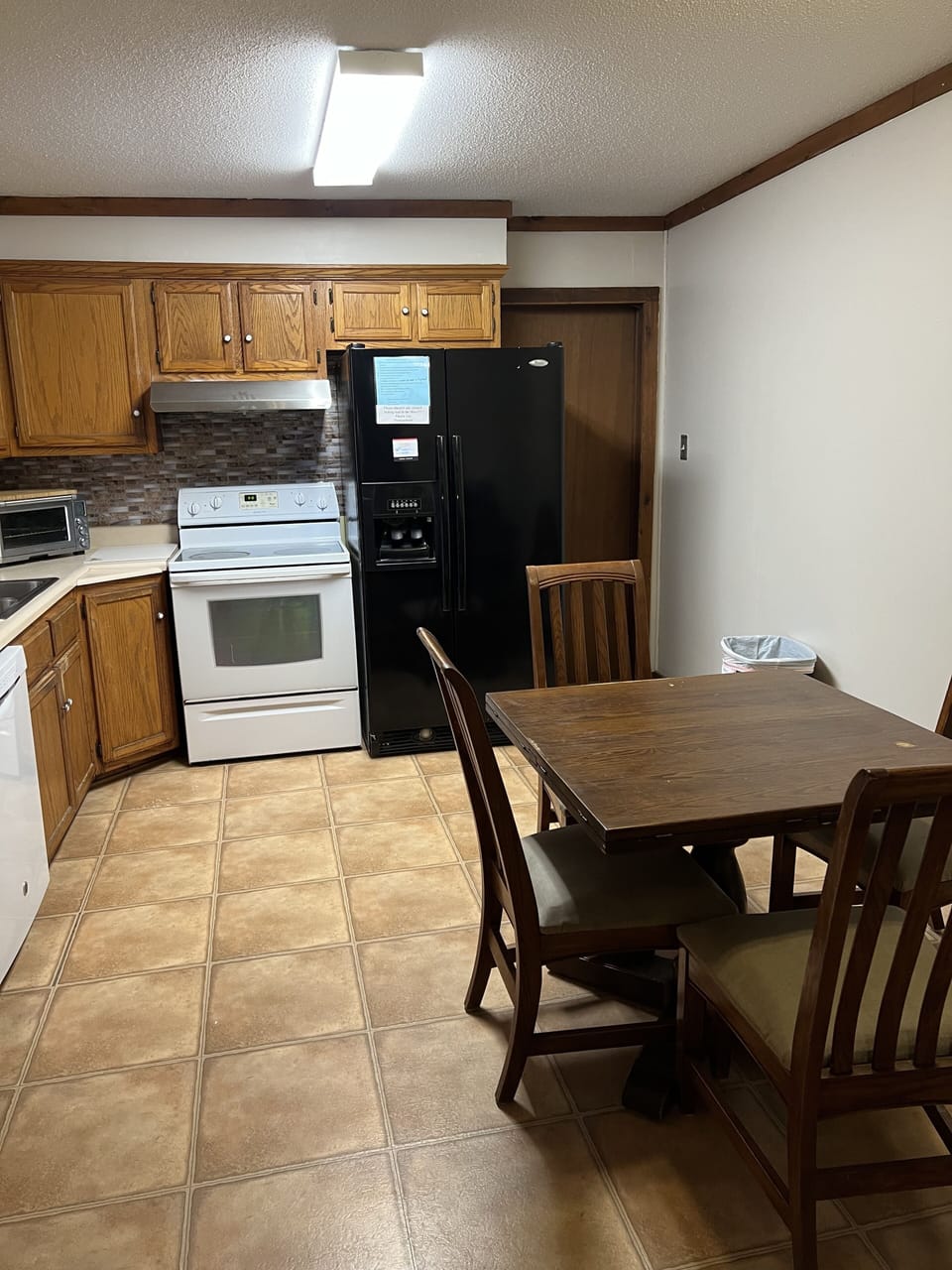 Kitchen with dishwasher, frig with ice maker, coffee pot, toaster oven,microwave