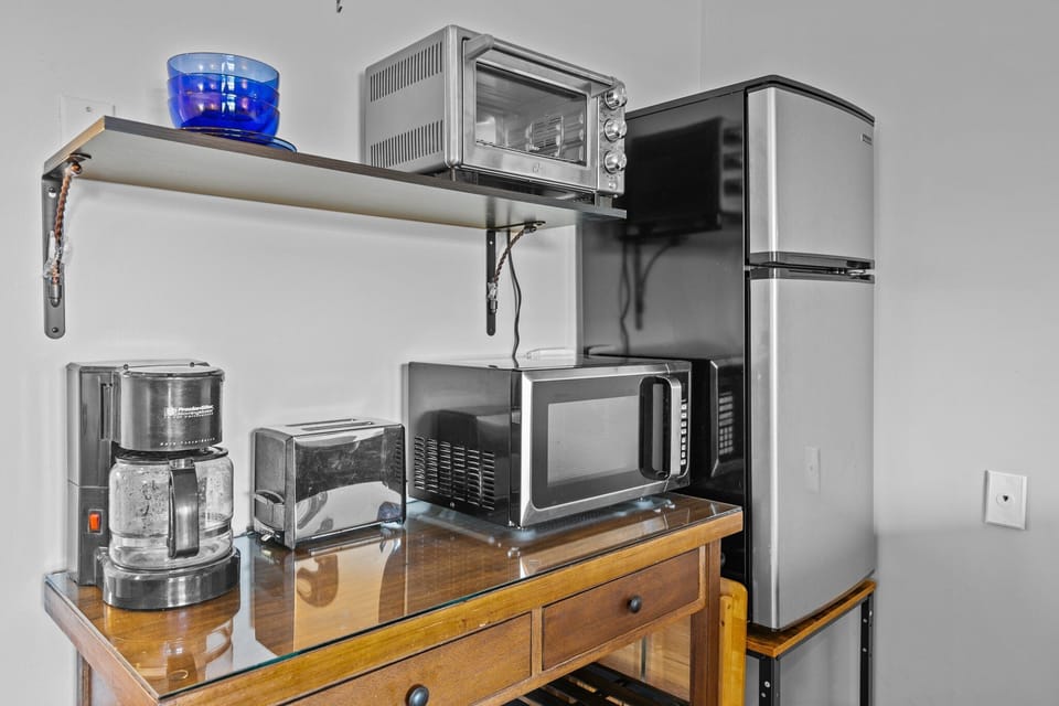 Mini fridge, coffee maker, toaster, microwave, and coffee provided.