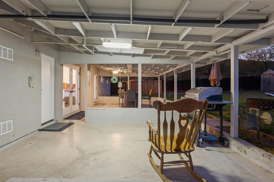 A wonderful covered patio, ready for your backyard BBQ and corn hole.