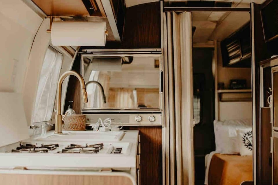 Full kitchen with 4 burner stovetop, gas oven, and bigger-than-mini fridge and freezer