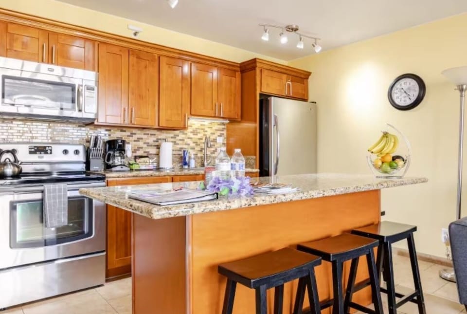 Full Kitchen with Refrigerator, Oven/Stove, Microwave, and Center Island.