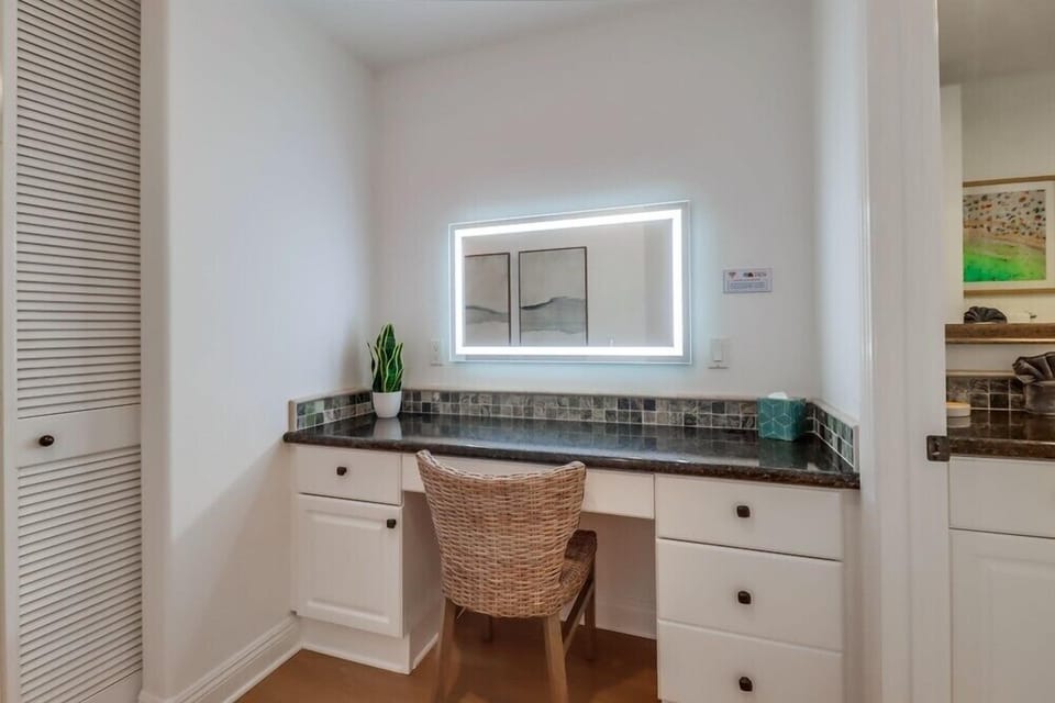 Dedicated work area that doubles as a makeup counter, offering a quiet, well lit space to get ready or catch up on emails.