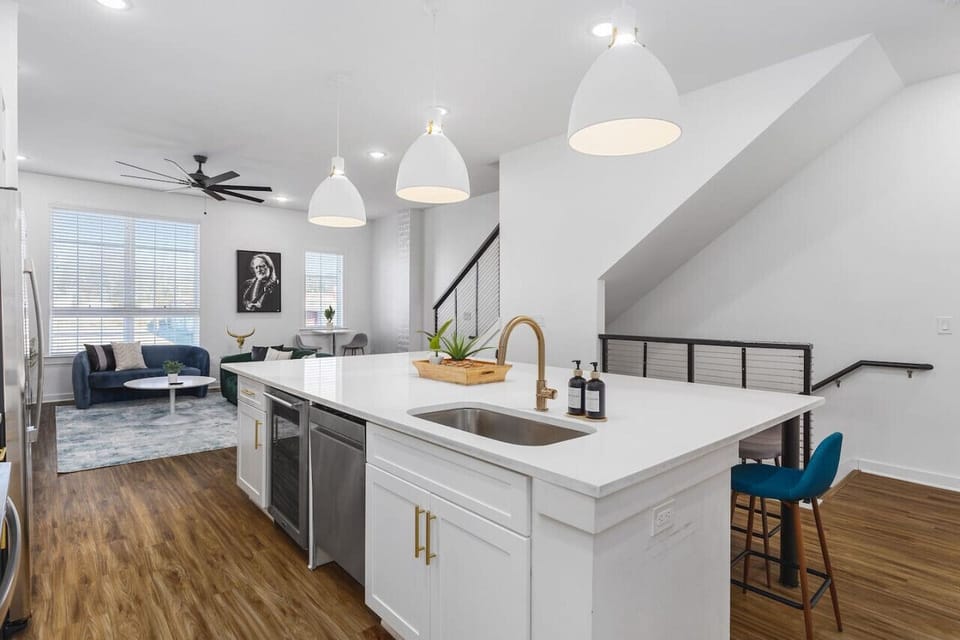 Huge kitchen on the main floor of the house with  a wine cooler, massive island, seating for 9, and all the appliances / supplies you'd need to cook a meal.