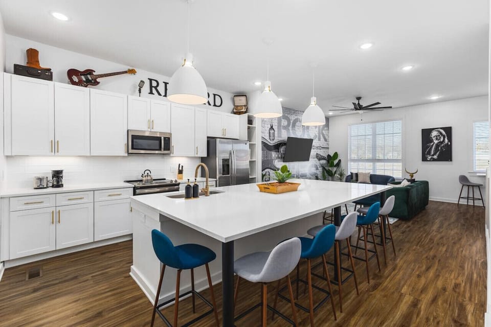 Huge kitchen on the main floor of the house with  a massive island, seating for 9, and all the appliances / supplies you'd need to cook a meal.