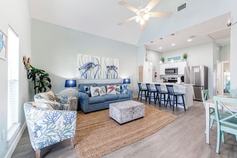 Unwind in your coastal-inspired living space where ocean blues meet crisp whites, creating the perfect backdrop for your beach getaway memories.