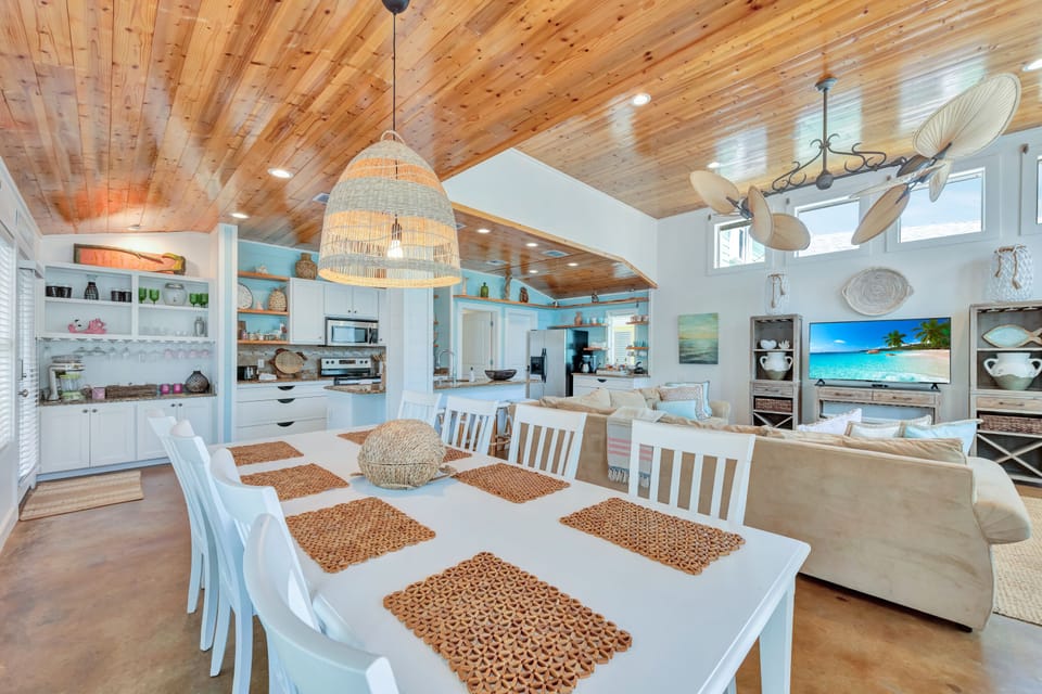 The dining table is open to the kitchen and seats eight guests comfortably.