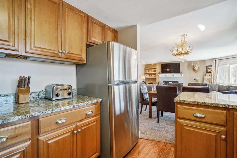 Kitchen, dining, and living spaces flow together perfectly for entertaining and reconnecting after the slopes.