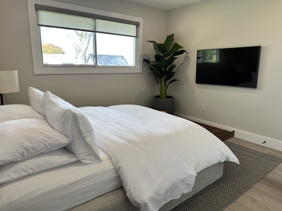 Second primary bedroom with queen-size bed and 50" smart TV.