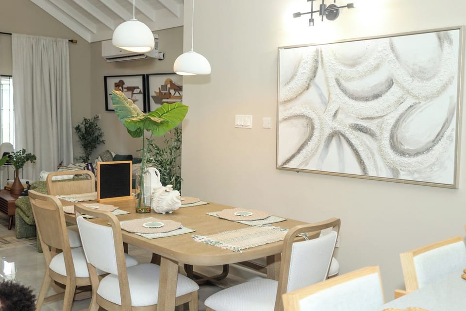 Chic dining area with natural light & tropical accents at Villa on the Rocks