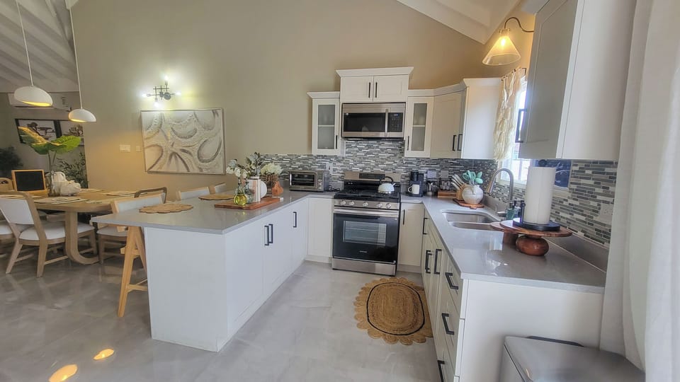 Fully equipped kitchen with modern appliances, cookware & island touches