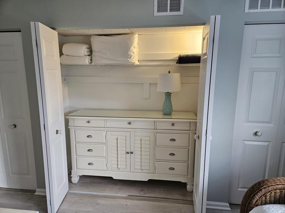 Closet with bureau and bed items