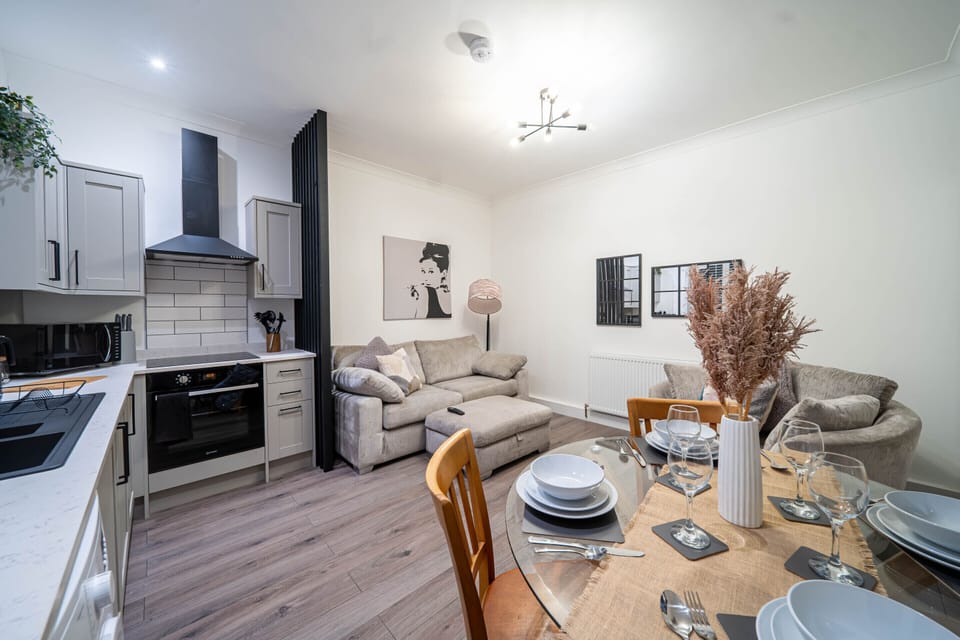 Bright and modern living area with open-plan kitchen and dining, designed for a comfortable stay.