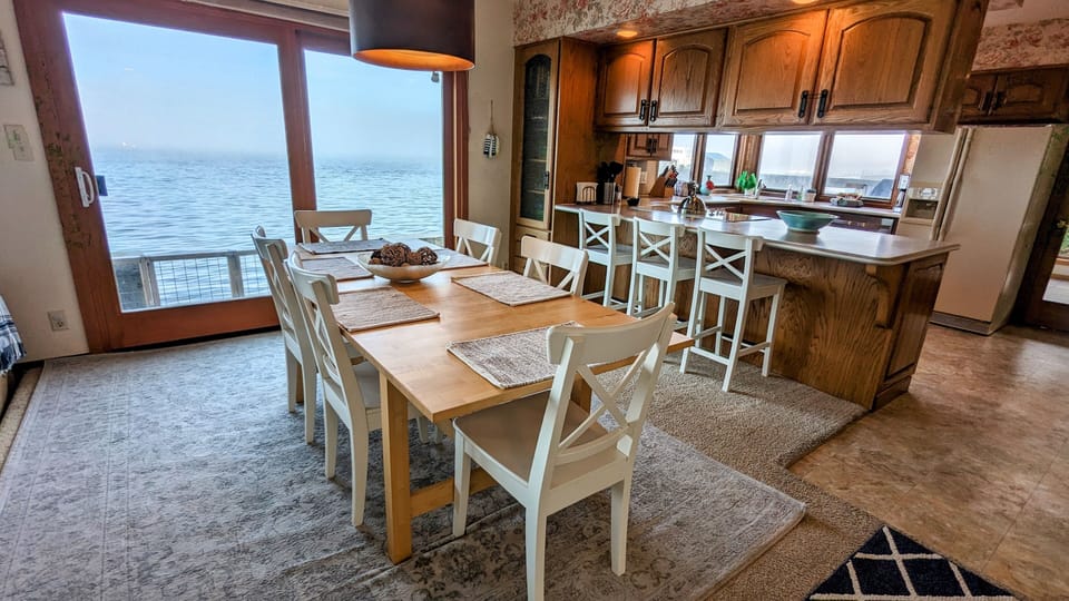 Dining area with sliding doors to the waterside patio