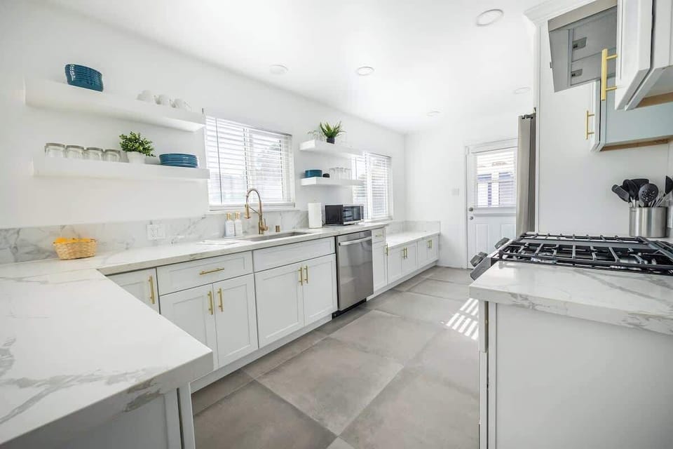 Kitchen: Complete with cookware and utensils, this bright kitchen offers a relaxing, homey feel.