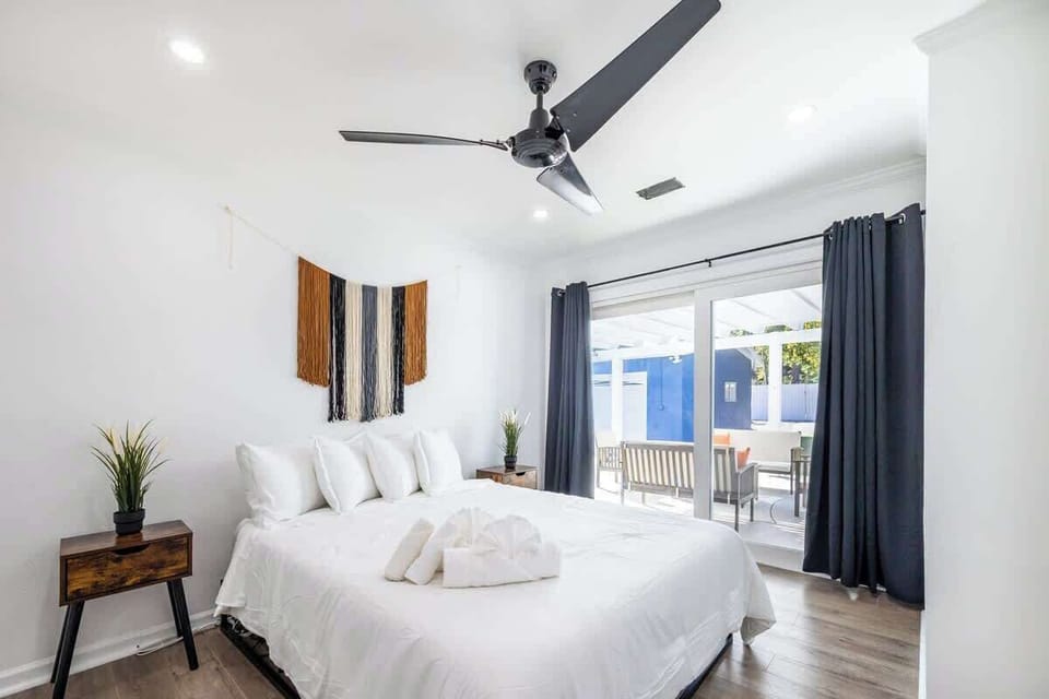Bedroom 1: Bright and airy space with large doors opening to the outdoors, allowing natural light and fresh air to flow in for a relaxing stay.
