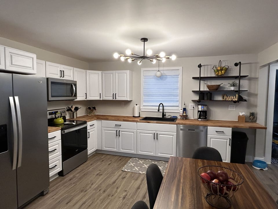 Large kitchen with oven, air fryer, dishwasher and refrigerator. 