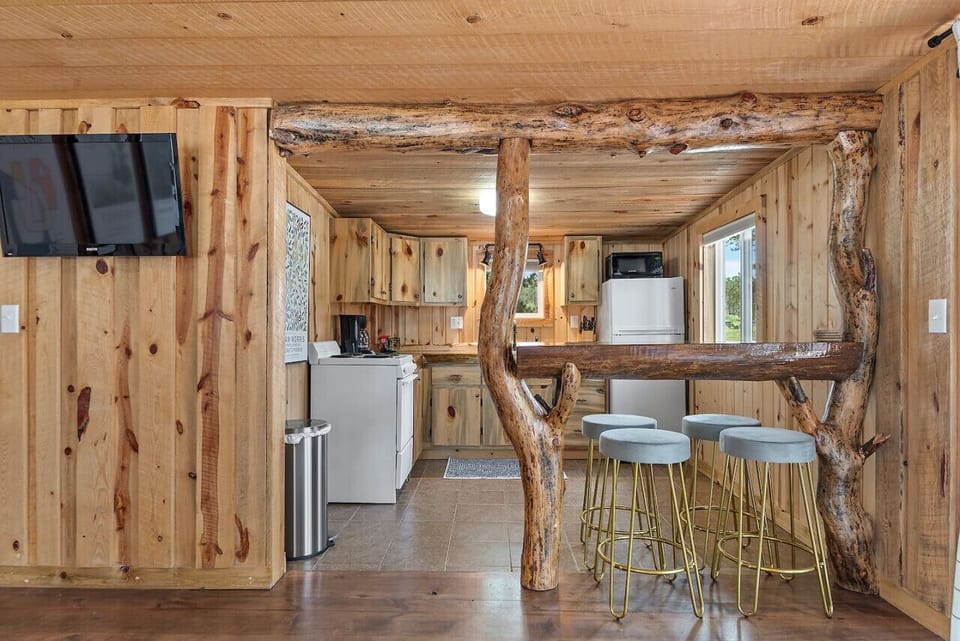 Kitchen Area with stove, refrigerator, kitchen stools, coffee maker, oven
