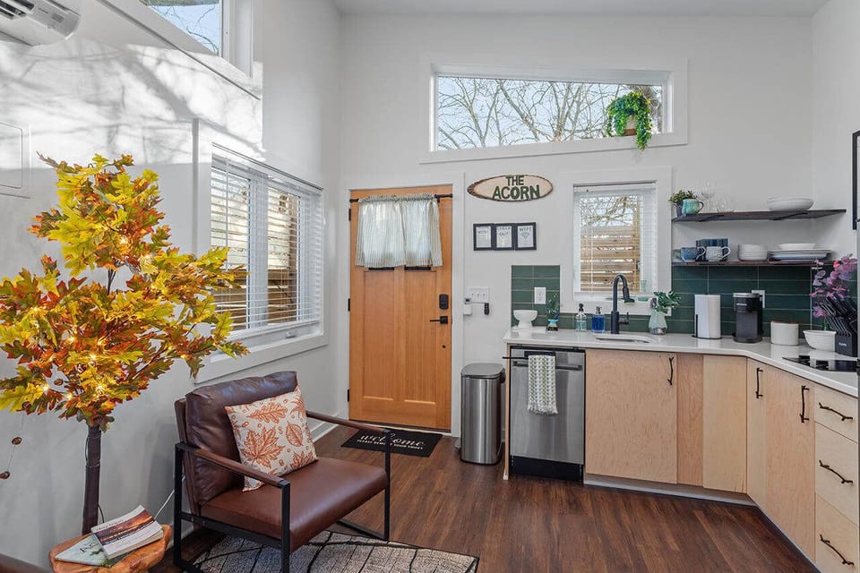 Simple, modern comfort with tasteful design elements—from the kitchen to the seasonal indoor tree and seating area