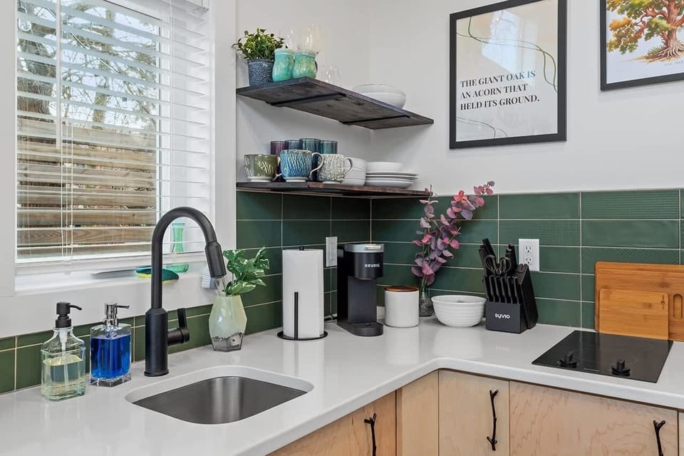Enjoy a fully equipped kitchen featuring stainless steel appliances, a microwave, and induction cooktop — perfect for home-cooked meals.