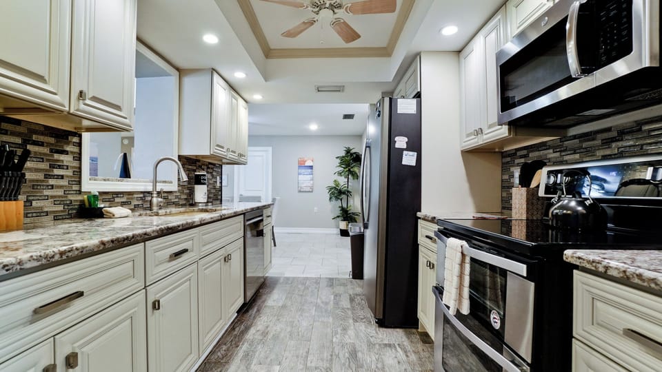 Fully stocked kitchen with stainless steel appliances