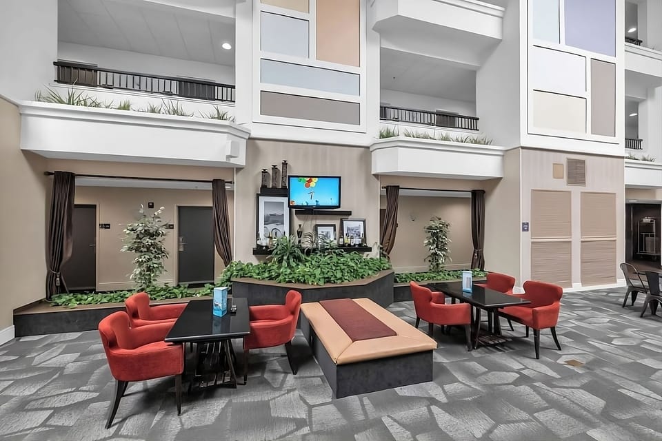 Unwind in cozy lounge seating with greenery and TV.