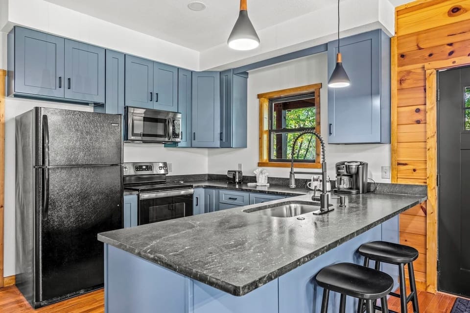 Kitchen: Sleek cabinetry meets rustic charm, perfect for culinary adventures with nature views!