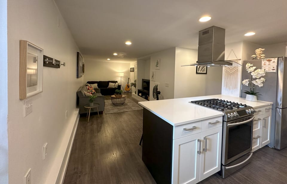 Full kitchen with gas range, refrigerator, dishwasher, microwave, and toaster.