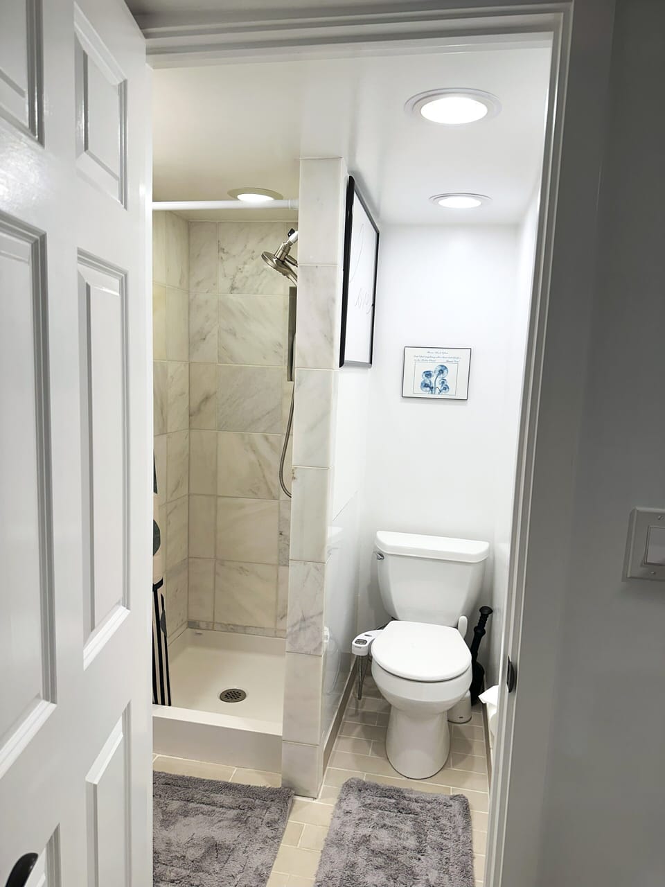 Marble tiled shower & toilet with bidet. Shower and toilet space are small/tight