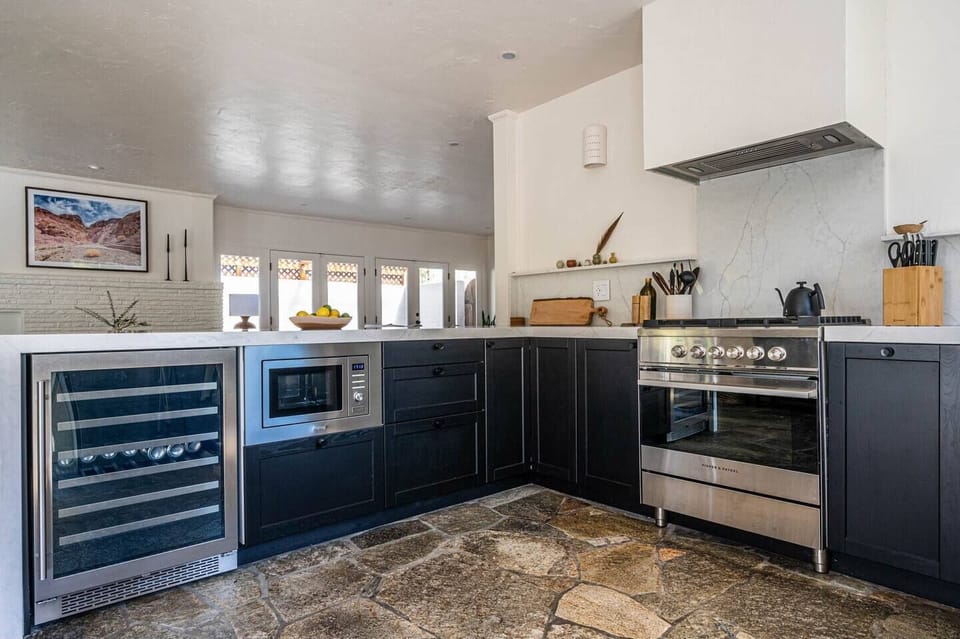 Fully equipped modern kitchen with sleek cabinetry and stainless appliances.