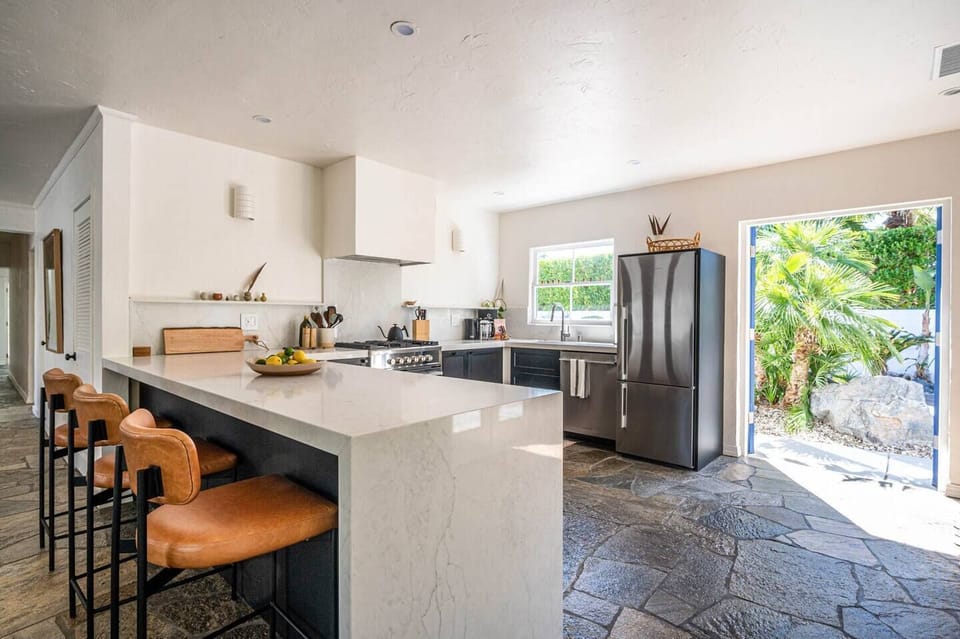 Chef’s kitchen with stainless steel appliances and island seating.