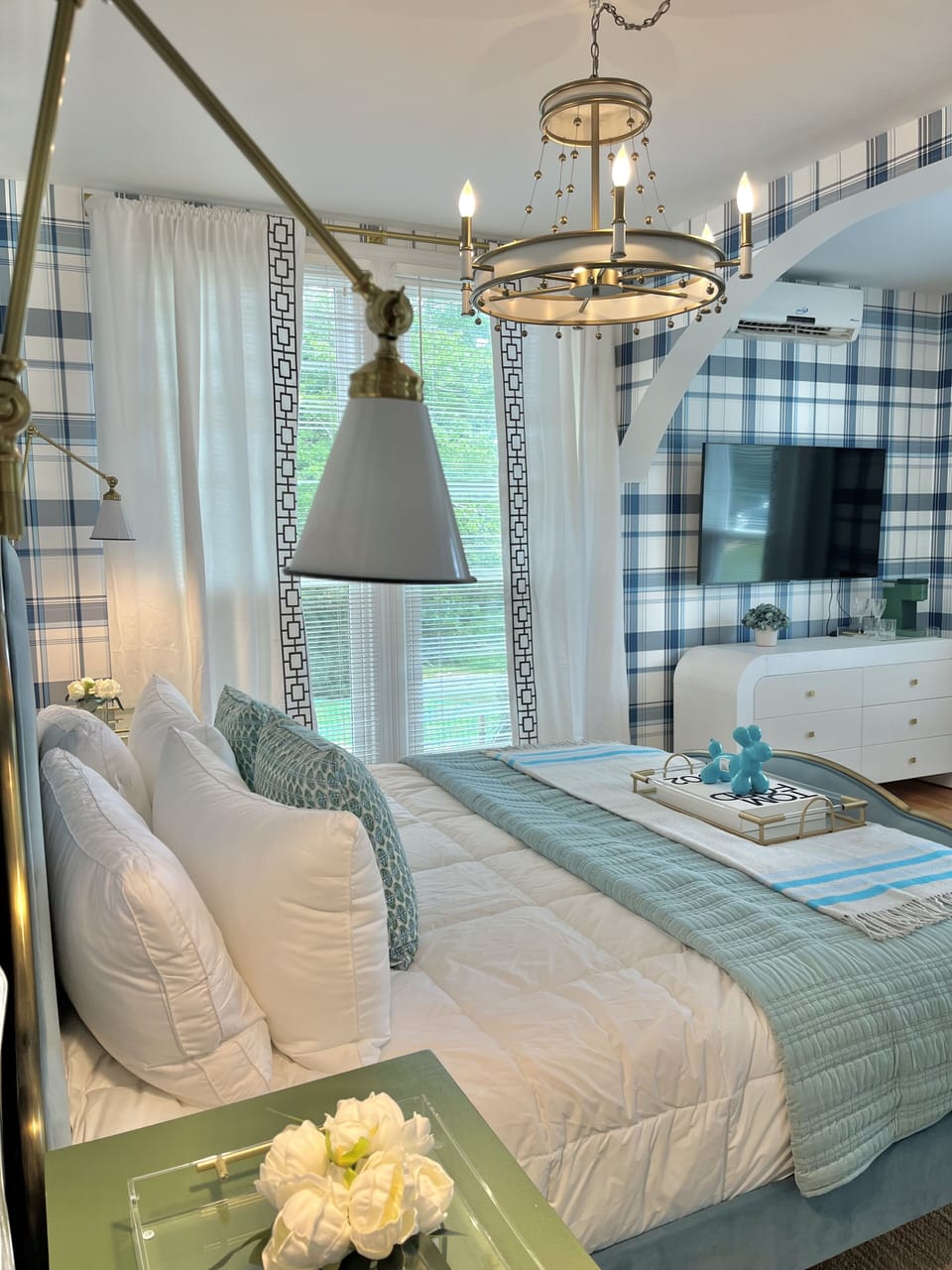 Suite 2: The largest suite with a King Anthropologie bed, seating area, 55" Smart TV, porcelain bath with a jacuzzi tub. Option to adjoin with Suite 1