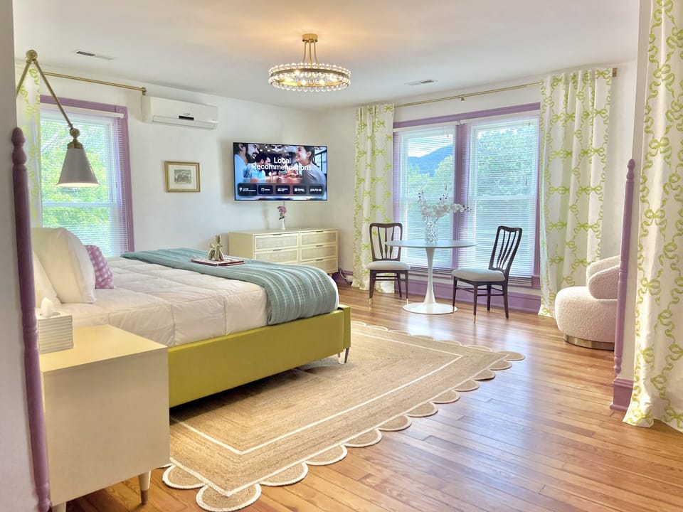 Suite 7: The second largest suite has a custom made King bed, 55" Smart TV, marble bath with glass enclosed two-head shower, seating nook, and access to a semi-private balcony that is shared by 2 other suites.