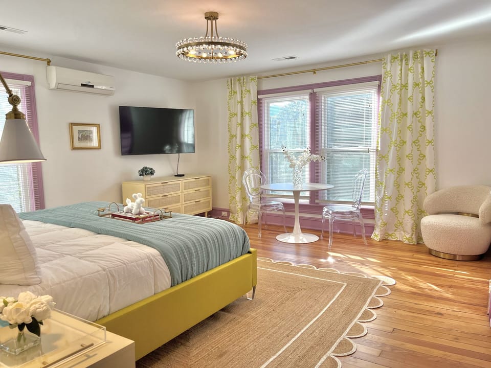 Suite 7: The second largest suite has a custom made King bed, 55" Smart TV, marble bath with glass enclosed two-head shower, seating nook, and access to a semi-private balcony that is shared by 2 other suites.
