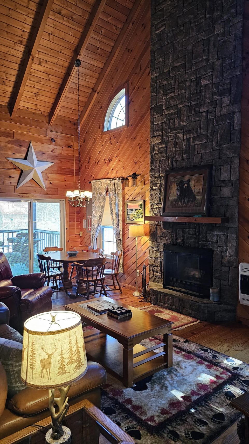 Cozy living room with vaulted ceilings and stone fireplace