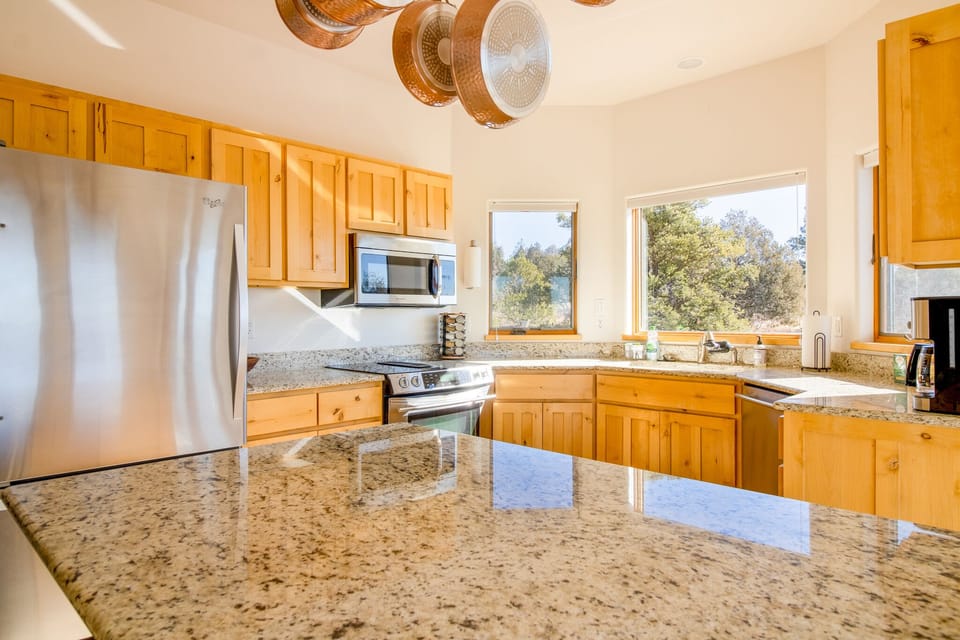 Stocked kitchen includes fridge/freezer, 4 burner stove, oven, and dishwasher