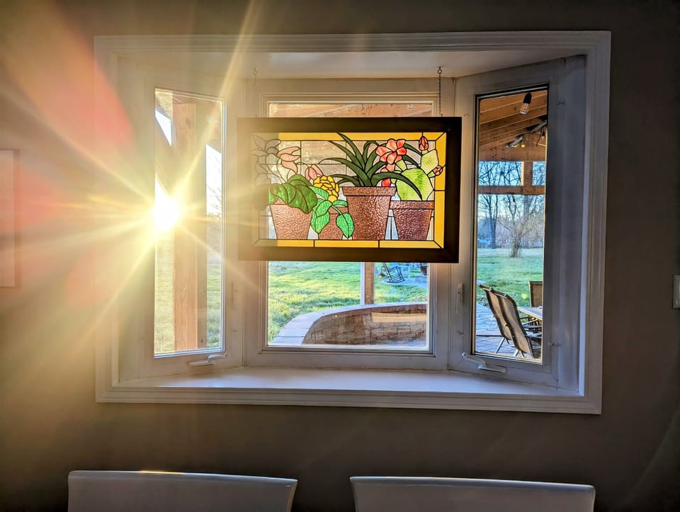 Enjoy the colorful sun set as it casts a vibrant rainbow over the back acreage. 