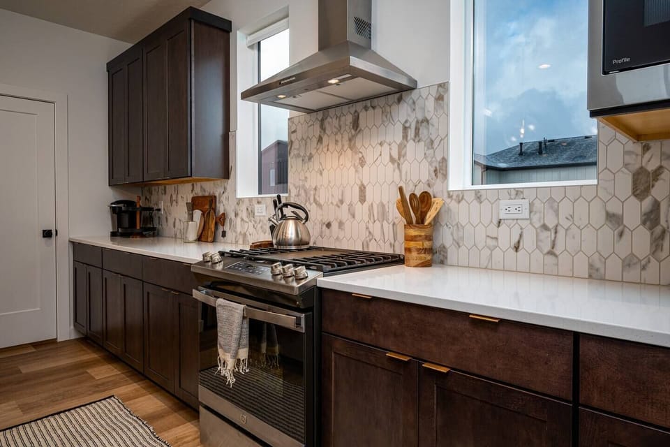 This well-equipped kitchen features a gas stove, large kettle, dishwasher, microwave, and other appliances for your convenience and culinary enjoyment.