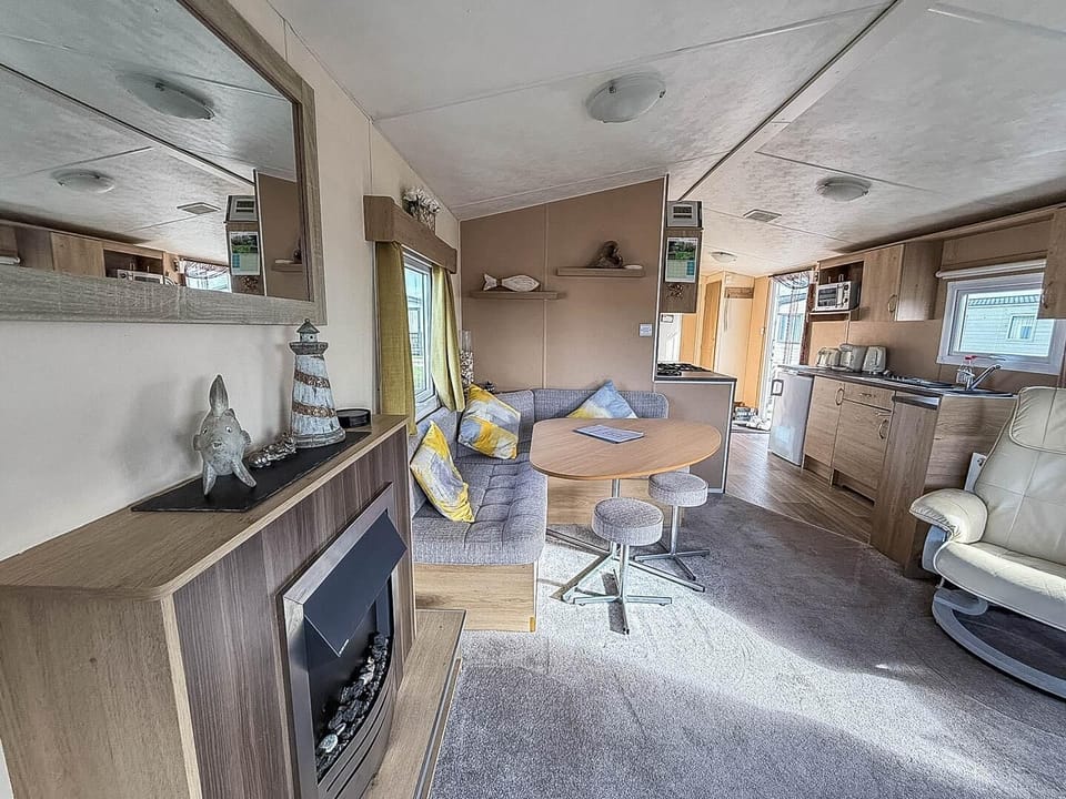 Cozy living area with fireplace and open kitchen layout